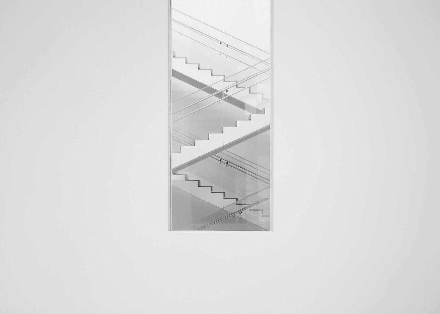 An opening in a wall revealing a staircase beyond